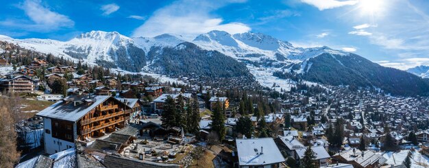 Aerial panorama of verbier switzerland alpine village and snowy mountains