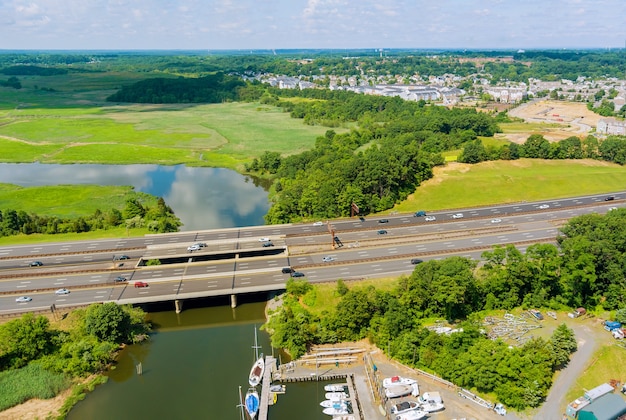 Aerial panorama view on highway traffic of cars driving on freeway across the bridge