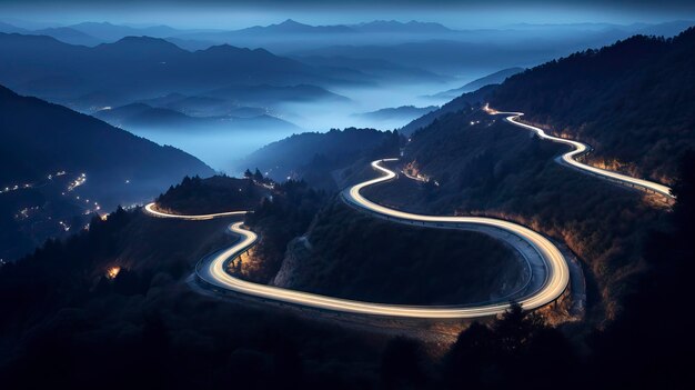 Aerial panoramic view of curvy mountain road with trailing lights at night