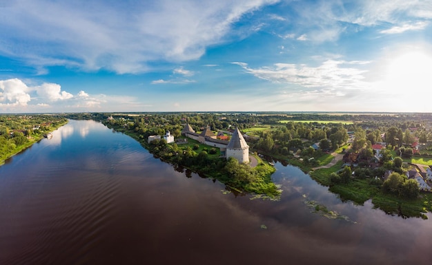 Aerial panoramic view of famous medieval fortress in Staraya Ladoga at sunset Ancient Russian historical fort on Volkhov River on a sunny summer day Europe Russia Leningrad region St Petersburg