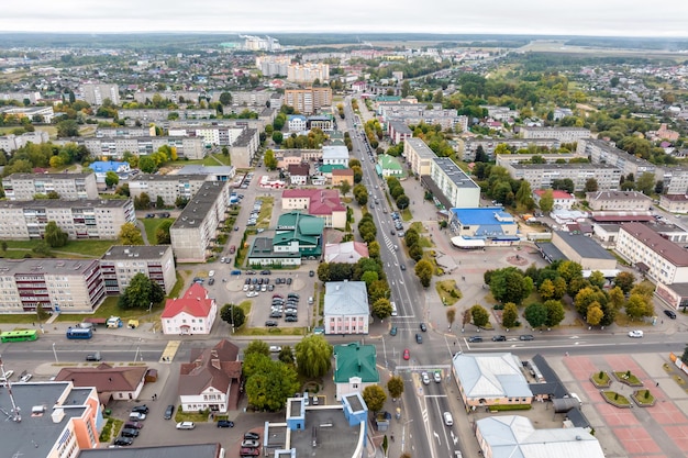 Aerial panoramic view from great height of provincial town with a private sector and highrise urban apartment buildings