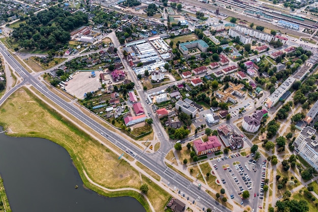 Aerial panoramic view from great height of provincial town with a private sector and highrise urban apartment buildings