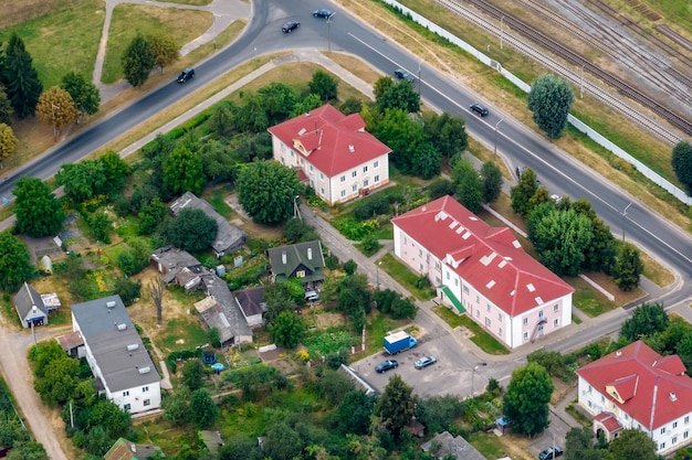 Aerial panoramic view from a great height of a small provincial\
green town with a private sector and highrise apartment\
buildings