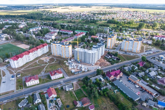 Aerial panoramic view from a great height of a small provincial town with a private sector and highrise apartment buildings