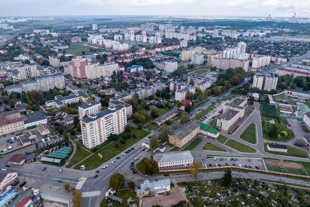 Aerial panoramic view from height of a multistorey residential\
complex and urban development in autumn day