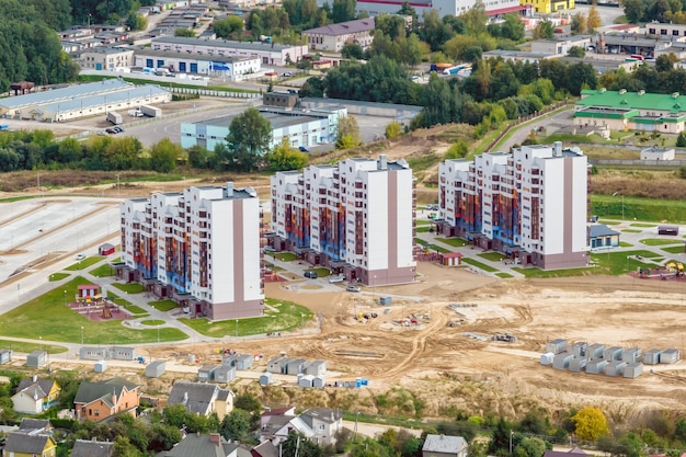 Aerial panoramic view from height of a multistorey residential complex and urban development in autumn day