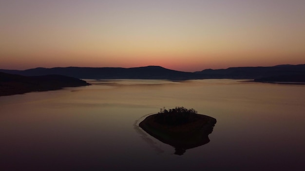 Aerial panoramic view of Island on a Batak Reservoir in sunrise Rhodopa Mountains Bulgaria