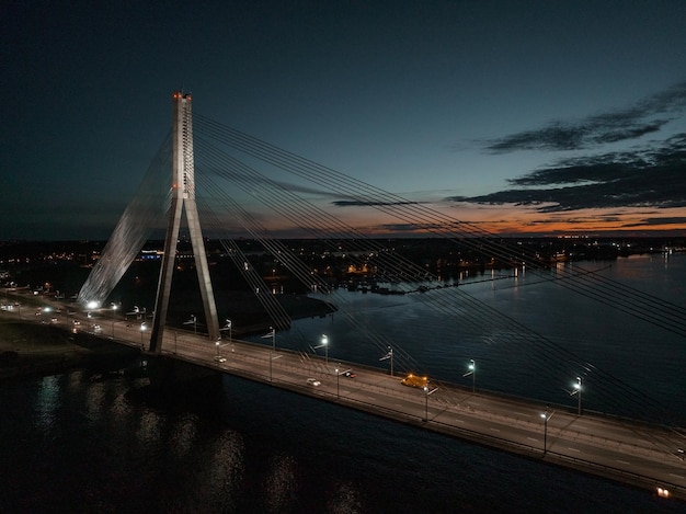 Aerial panoramic view of the riga bridge across river daugava at night