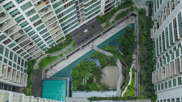 Aerial people in decorative garden outside apartment blocks