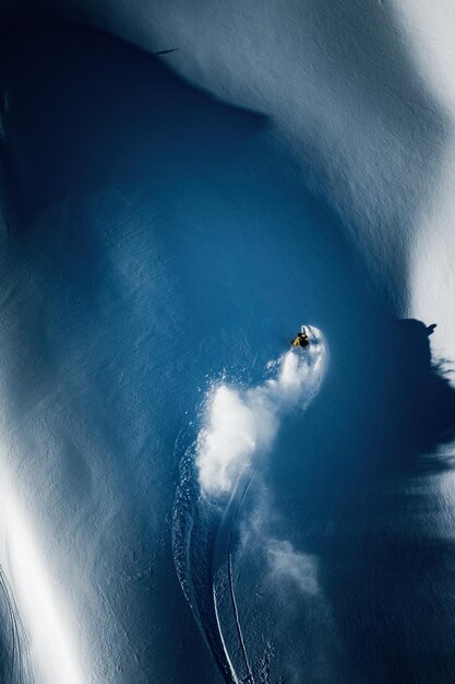 Aerial photo of adult man backcountry powder skiing in the kootenays bc canada