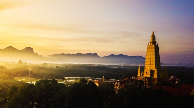 Aerial photo  of Beautiful temples in the morning atmosphere , Thailand .