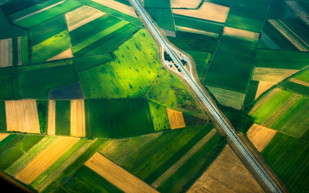 Aerial photo from a plane top view road through the fields