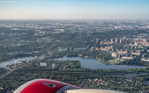 Aerial photo of large city from an airplane window view of city of Moscow through window from plane