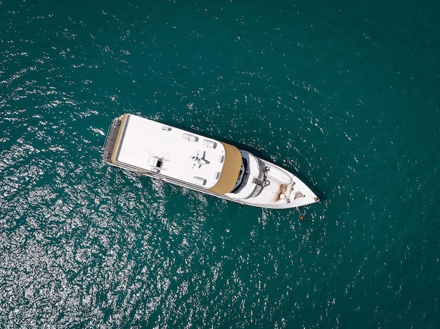 Aerial picture of an isolated yacht with brown wooden design in the sea. Andaman sea