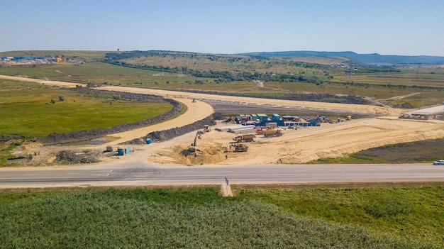 Aerial Road Building Site Flight Over Construction Crews And Heavy Equipment