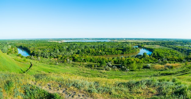 Photo aerial shot of the beautiful russian river among the green hills in krasnodarsky kray, russia, kuban river.