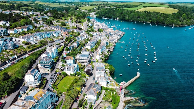 Aerial shot of the Falmouth Cornwall village on the coast of a beach surrounded by hills