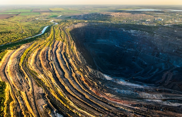 Aerial shot of huge open pit at sunset