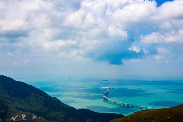 Aerial shot of lantau island in hong kong with a bridge in the ocean