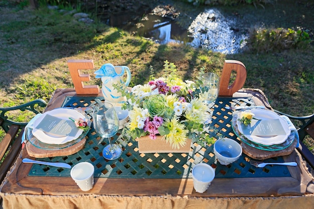 Aerial shot of rustic decorated wedding table in the field at sunset