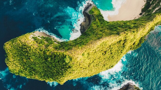 Aerial shot of the tropical coast of the island of Nusa Penida beach of Kelingking Indonesia amazing beach with blue water