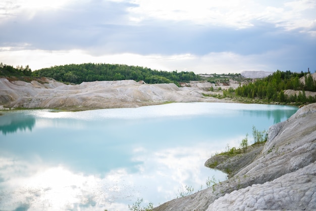 Aerial spectacular view to scenic valley with beautiful mountain lake, conifer forest and rocky mountains. Amazing atmospheric highland landscape. Wonderful majestic wilderness nature scenery.