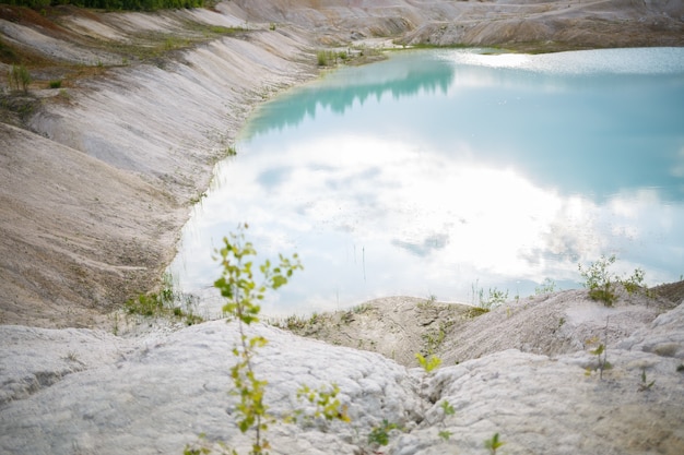 Aerial spectacular view to scenic valley with beautiful mountain lake, conifer forest and rocky mountains. Amazing atmospheric highland landscape. Wonderful majestic wilderness nature scenery.