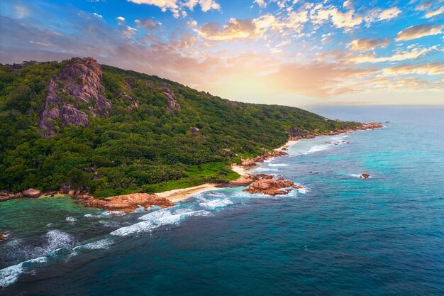 Aerial sunset view of anse source dargent beach at la digue island seychelles