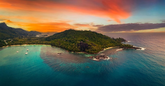 Aerial sunset view of port launay beach at mahe island seychelles