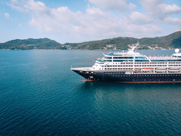 Aerial top down view of travel ship nose part in the open sea