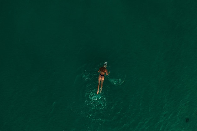 aerial top nature view green turquoise thracian sea greece ellada. beautiful young woman bikini