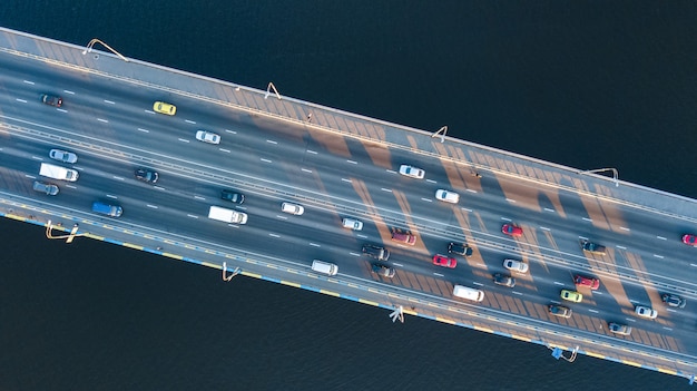 Aerial top view of bridge road automobile traffic jam of many cars from above, city transportation concept