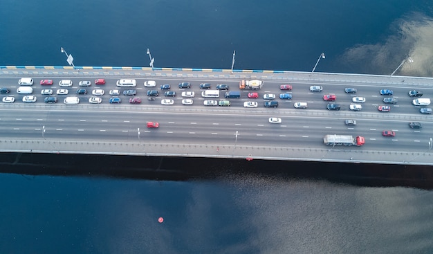 Вид с воздуха на мостовую автомобильную пробку из многих автомобилей сверху городского транспорта