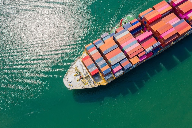 Aerial top view of cargo ship carrying container for import export goods to customer