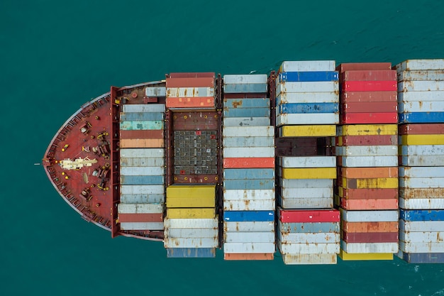 Aerial top view of cargo ship carrying container for import export goods to customer