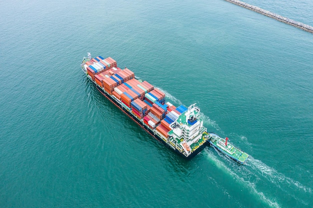 Aerial top view of cargo ship carrying container for import export