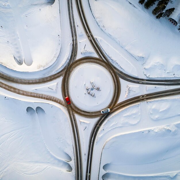 Aerial top view of country road junction in winter time snow forest road travel and transportation concept