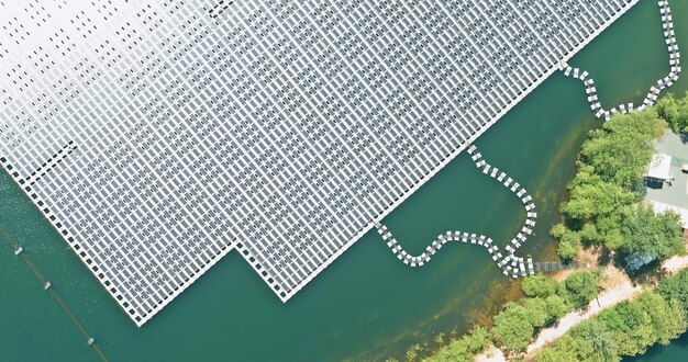 Aerial top view of electric power industry solar panels on floating in lake water renewable energy eco technology