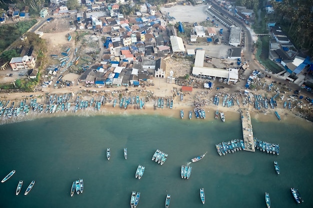 Aerial top view of fishing harbour with many traditional fisherman boats in kerala india