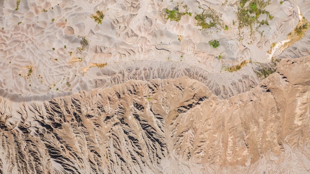 Aerial top view, land surface, Left by water