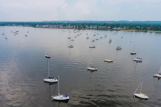 Aerial top view of many fishing boats yachts near marina in a bay