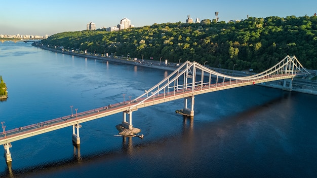 Aerial top view of pedestrian Park bridge and Dnieper river from above, city of Kiev, Ukraine