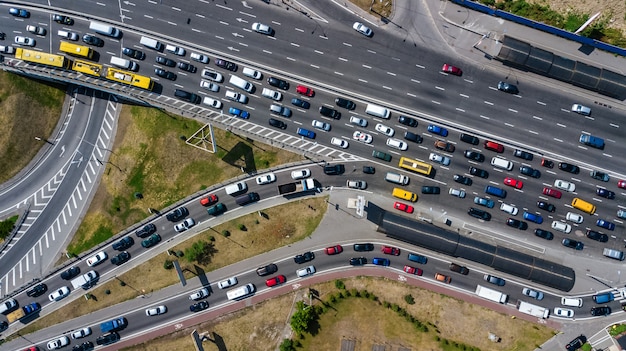 Aerial top view of road junction from above, automobile traffic and jam of many cars, transportation concept