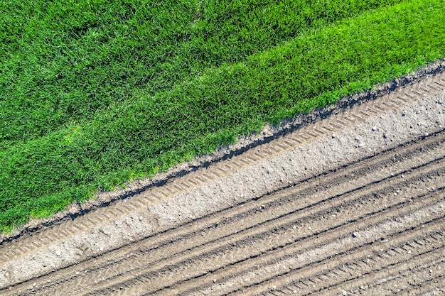 Aerial top view Rows of soil before and after planting