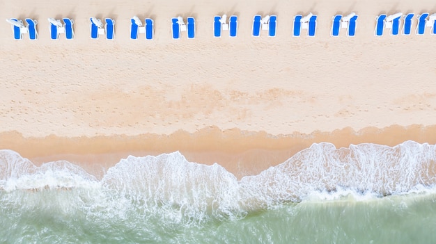 Aerial top view on the sandy beach. Umbrellas.