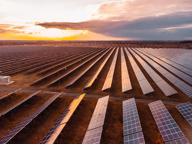 Aerial top view of a solar panels power plant photovoltaic solar panels at sunrise and sunset in