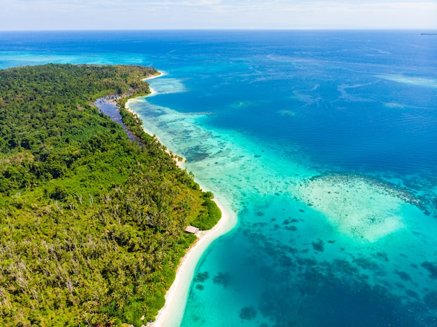 Aerial top view of tropical paradise pristine beach. Rainforest  and blue lagoon bay coral reef