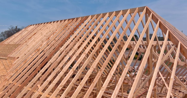 An aerial top view of an unfinished house with a wooden beam house construction process