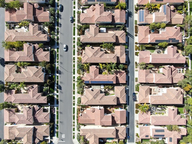 Aerial top view of urban sprawl. Suburban packed homes neighborhood with road. Vast subdivision.