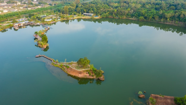 Aerial top view walking bridge in the river on island in the park 